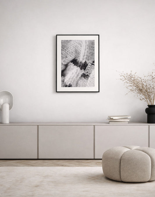 Black and white framed artwork displayed in a calm minimalist interior