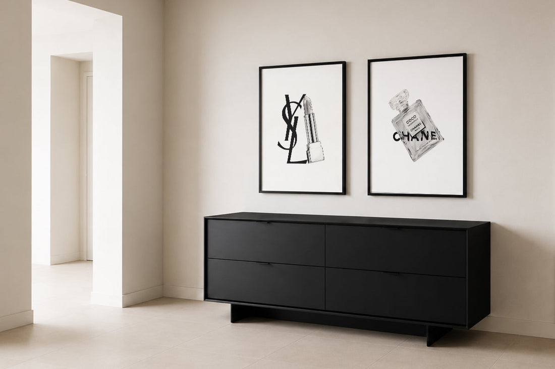 Framed black-and-white artworks in a calm contemporary interior with a black console
